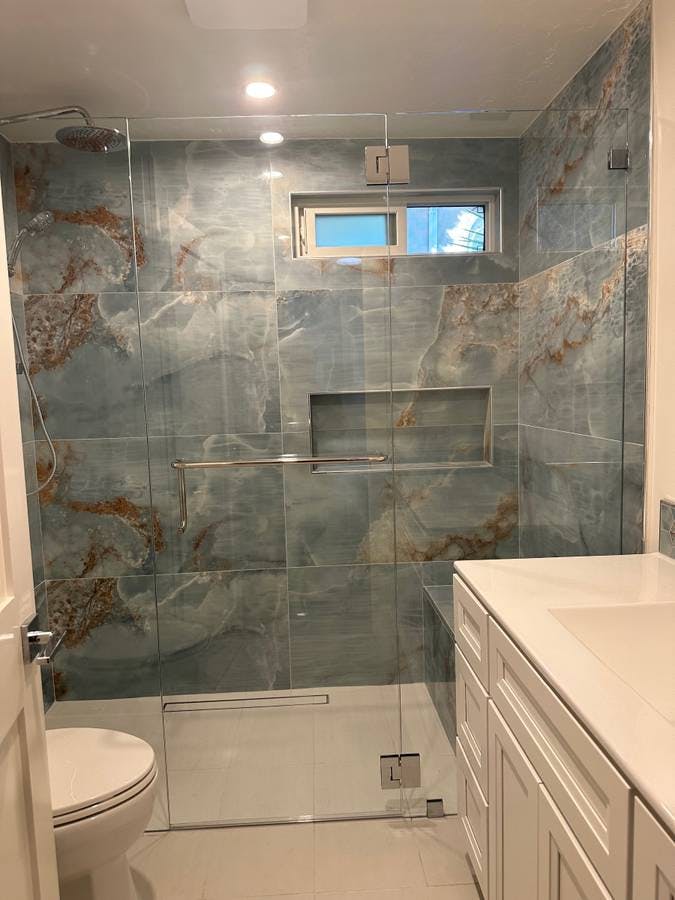 newly remodeled bathroom shower with textured granite and orcelain