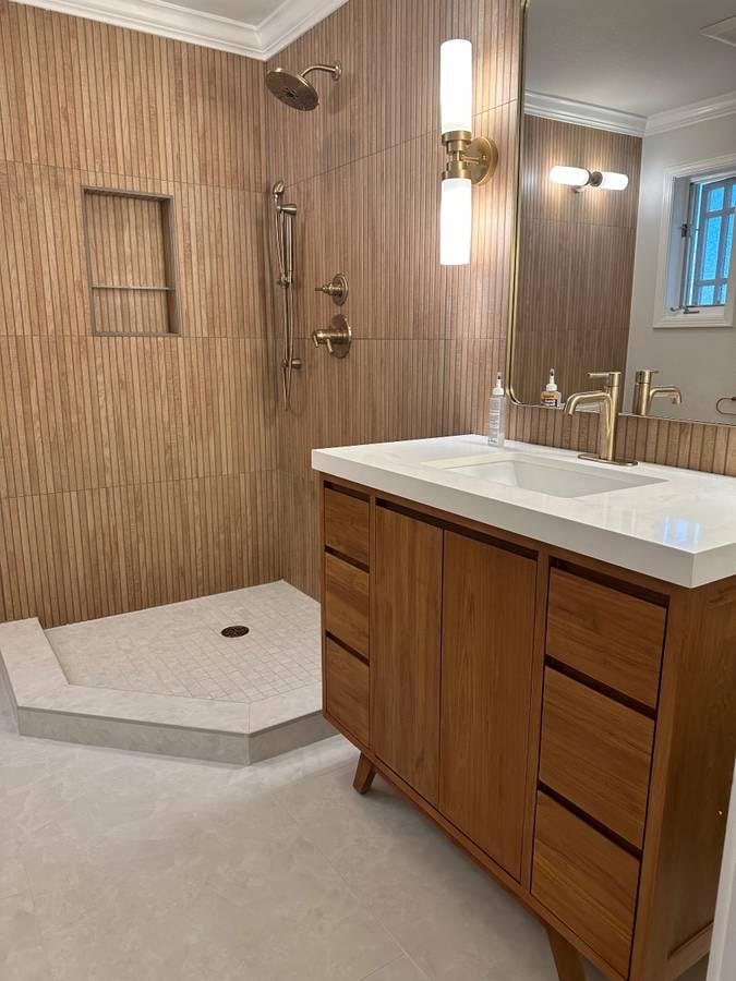 newly remodeled bathroom with luxury granite sink countertop and new tile bathroom walls