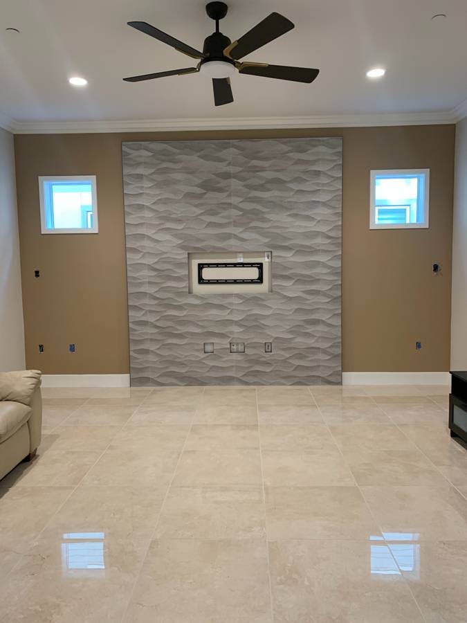 newly remodeled basement with new earl tile and a television granite tile backsplash