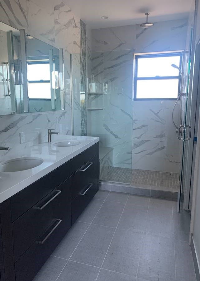 newly remodeled bathroom with granite sink and walls